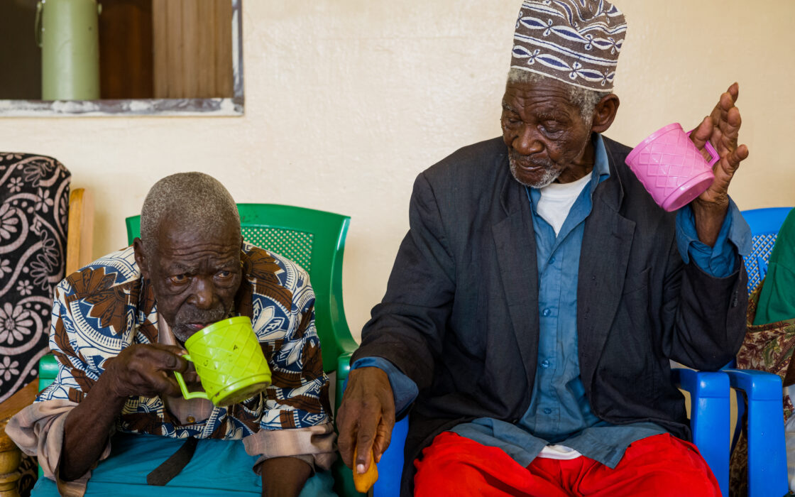Two elderly men drinking chai tea