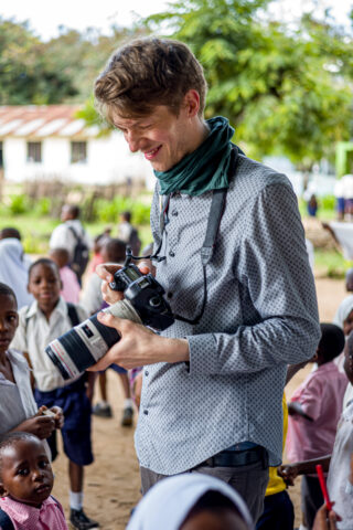 Cameraman among curious children