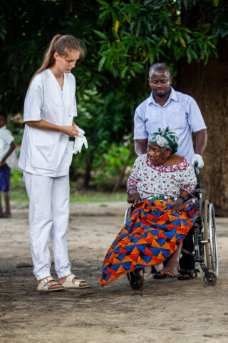 Student preparing to take care of an elderly woman in a wheelchair