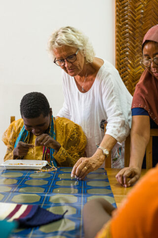 Ruth helping in picking up pearls for a necklace being made by a patient