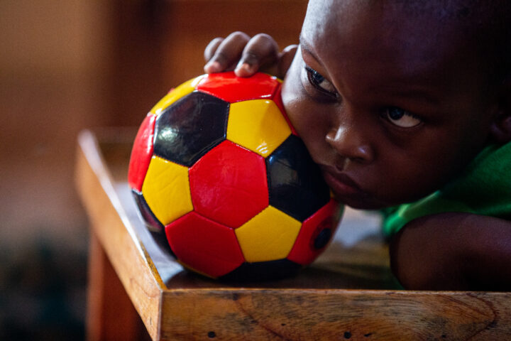 Child paying attention while holding a football