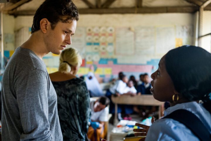 Visitor speaking with a woman working in one of the schools TICC helps