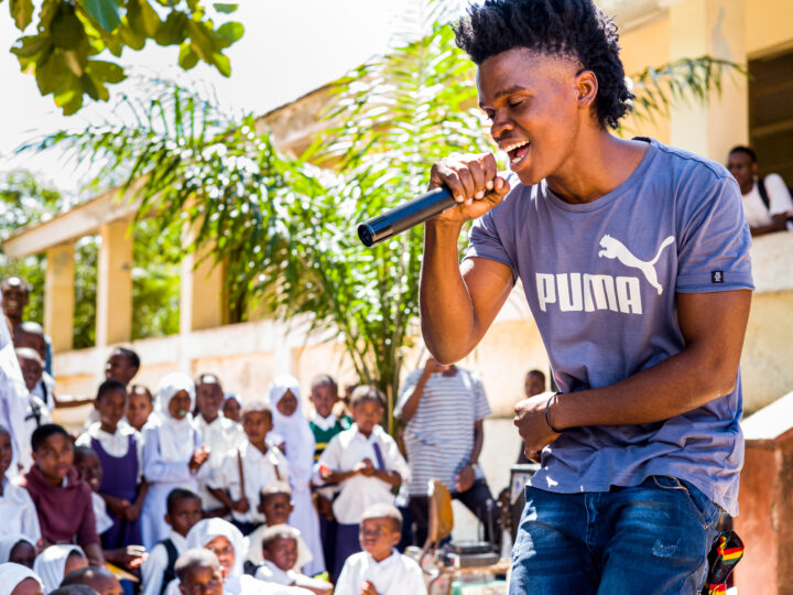 Member of the Youth Group Program singing in a campaign